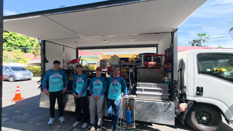 Tingkad Softwash team of four prepared for roof cleaning with full softwash equipment