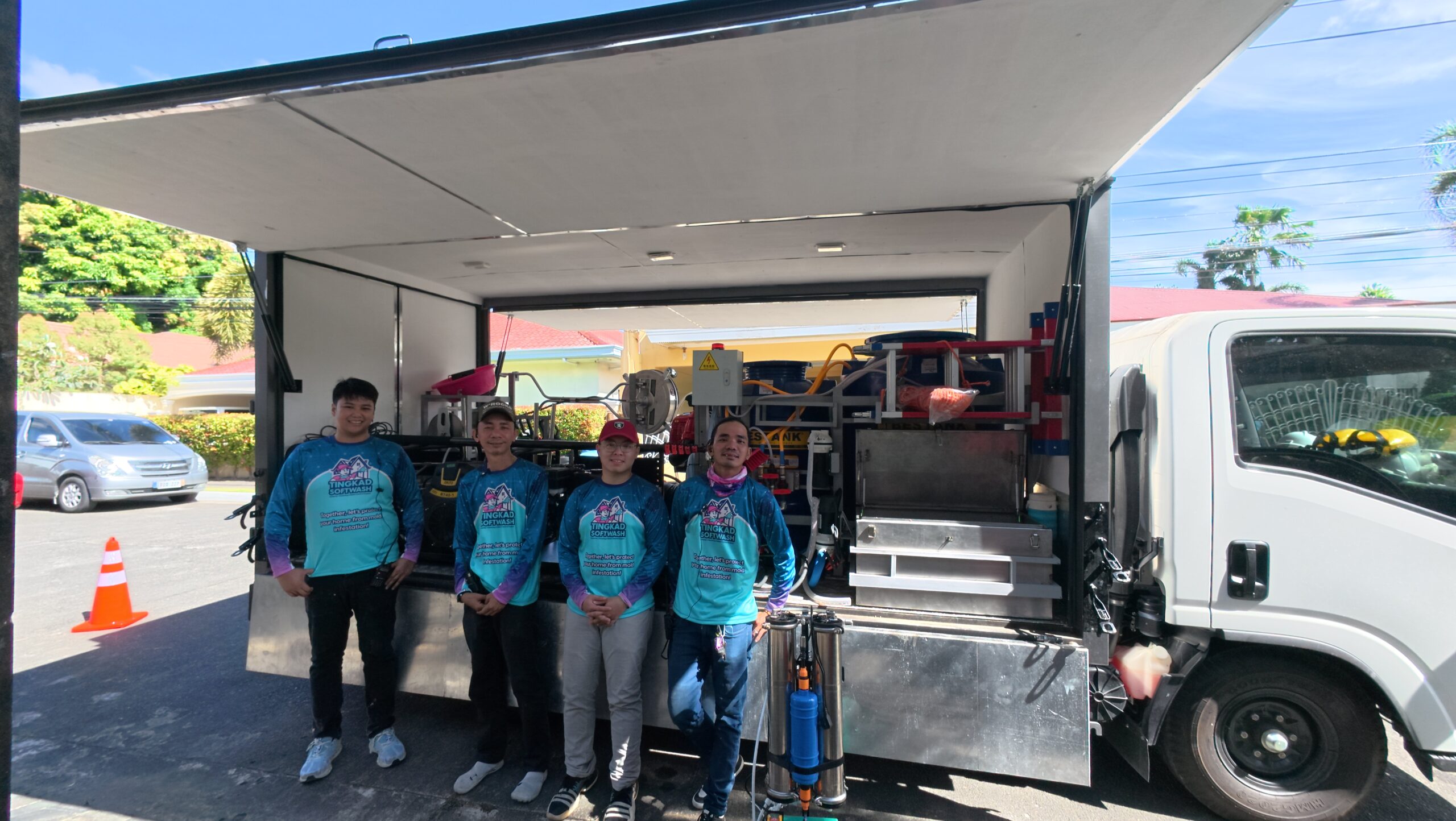 Tingkad Softwash team of four prepared for roof cleaning with full softwash equipment