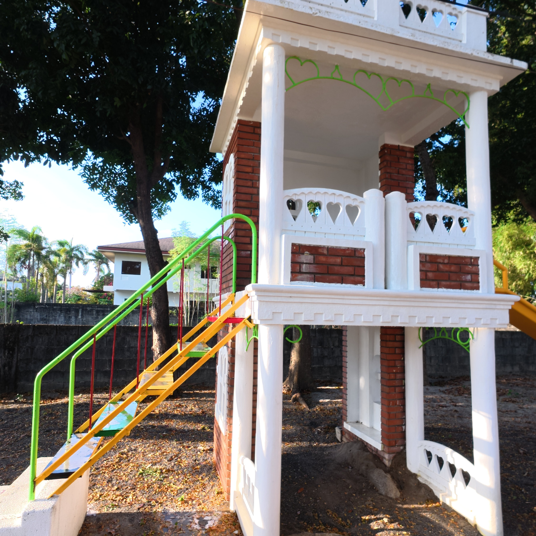 Cleaned outdoor play area featuring bright white pillars and restored brickwork after professional exterior cleaning.