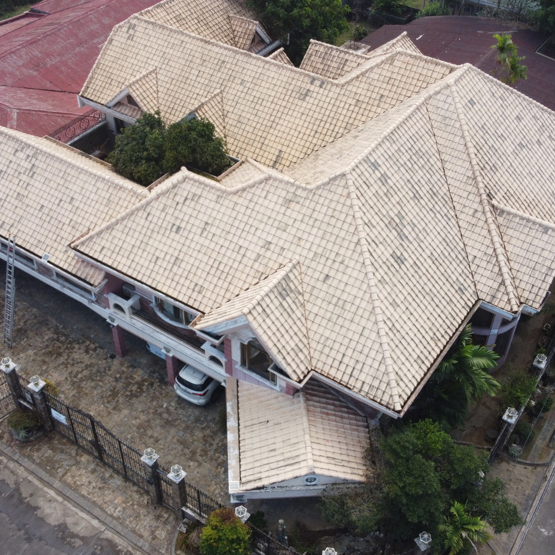 Clean residential tile roof restoration using low-pressure softwashing techniques to remove moss and algae.