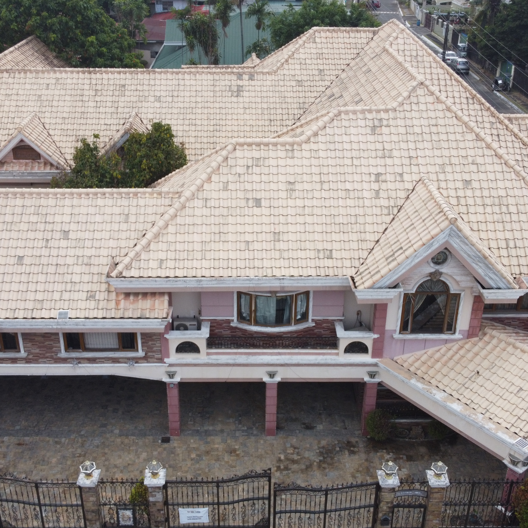Clean residential tile roof restoration using low-pressure softwashing techniques to remove moss and algae.