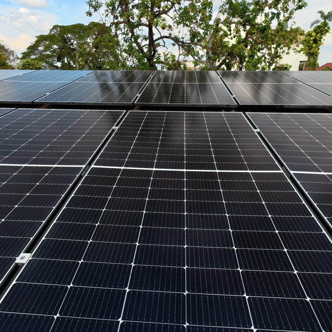High-angle drone shot of a fully cleaned solar power system on a commercial building roof.