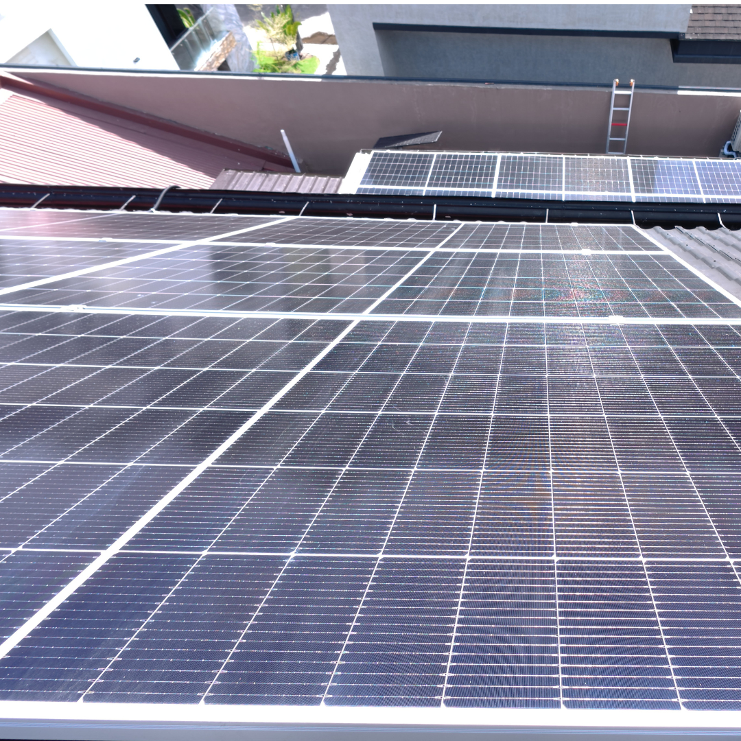 Clean, high-efficiency solar panel array on a residential roof reflecting the clear sky after a specialized wash.