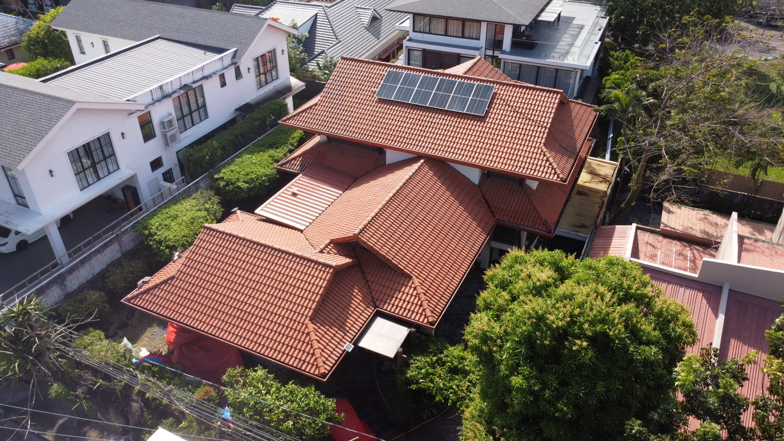 Aerial view of a completed residential exterior and roof softwashing project managed by the Tingkad Softwash team.